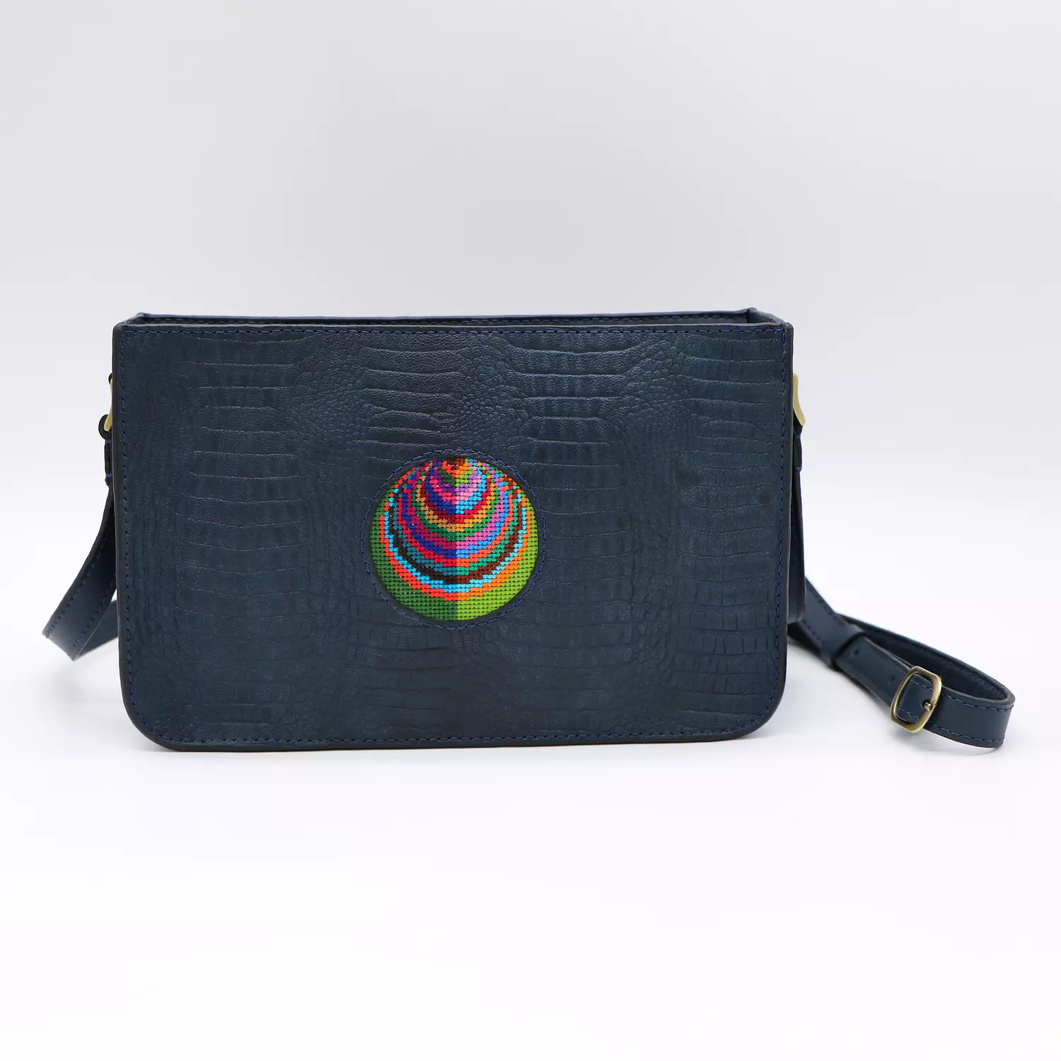 Dark blue genuine leather bag with colorful Cross stitching. hover image