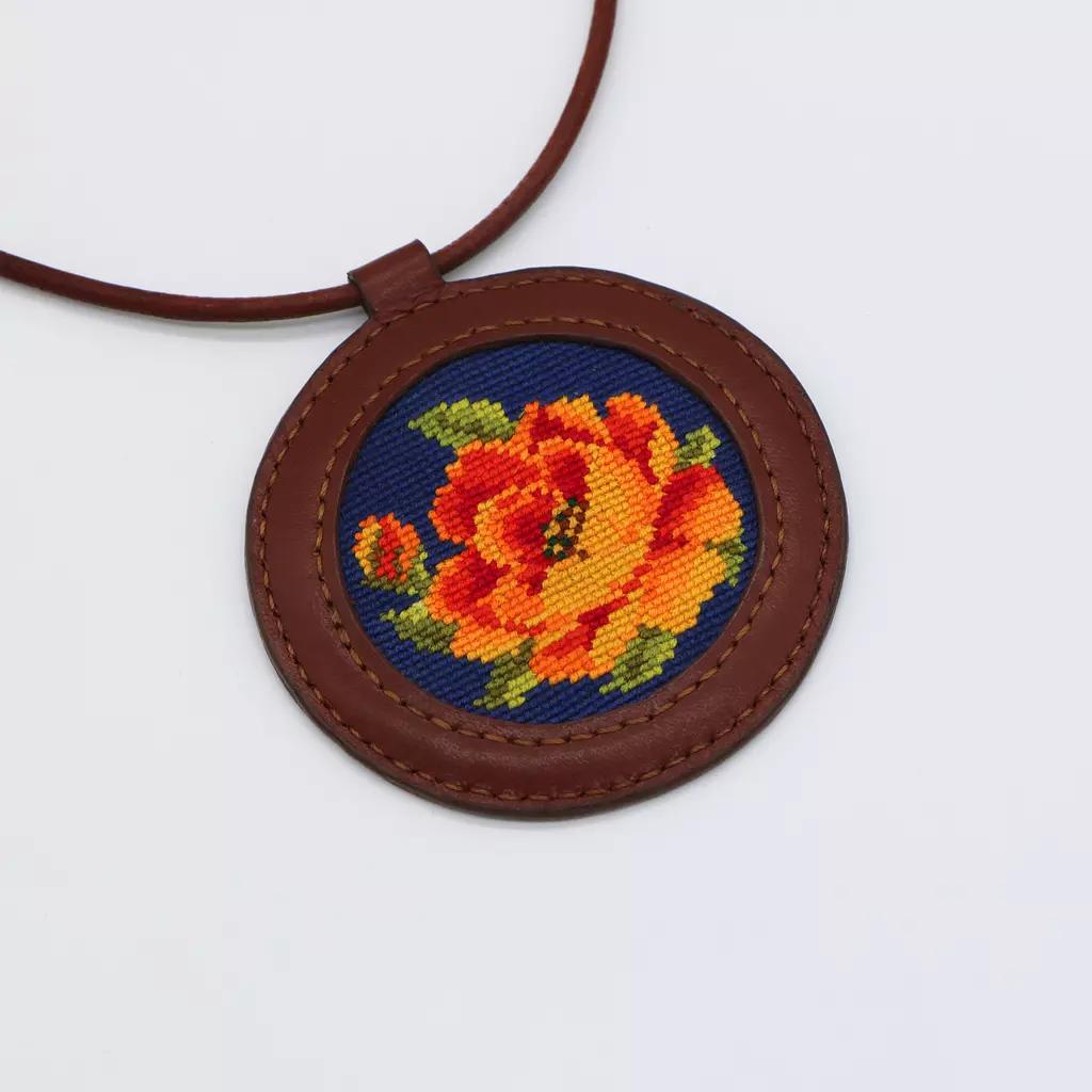 Genuine leather necklace with floral cross-stitching.