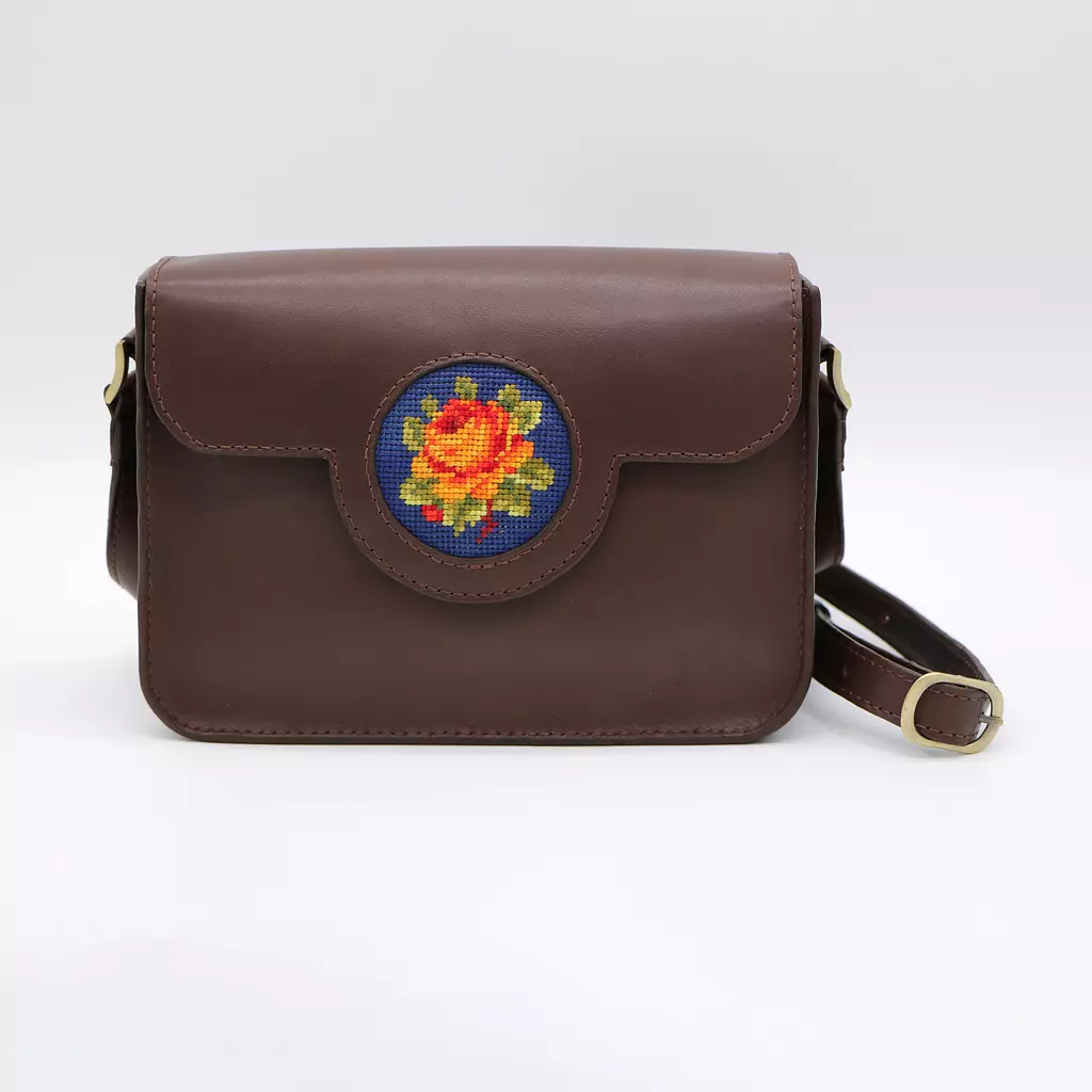  Genuine leather bag with floral design.