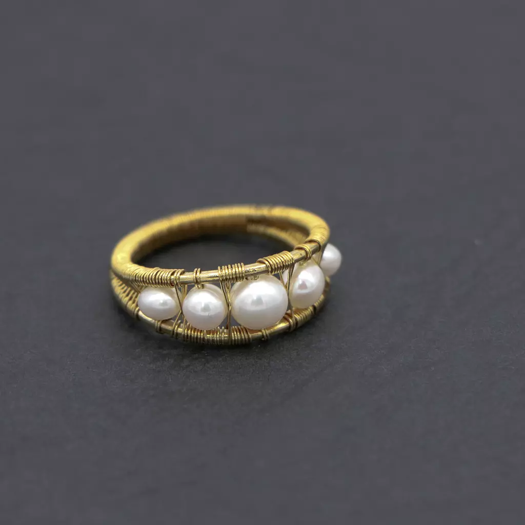 Wire wrapped brass ring with pearls.