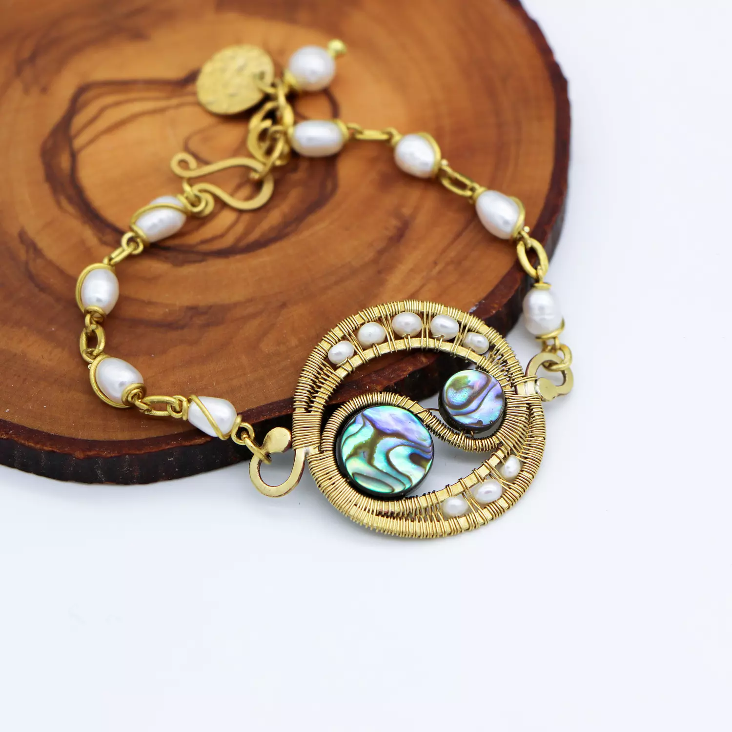 Brass bracelet with pearls and abalone shells. hover image