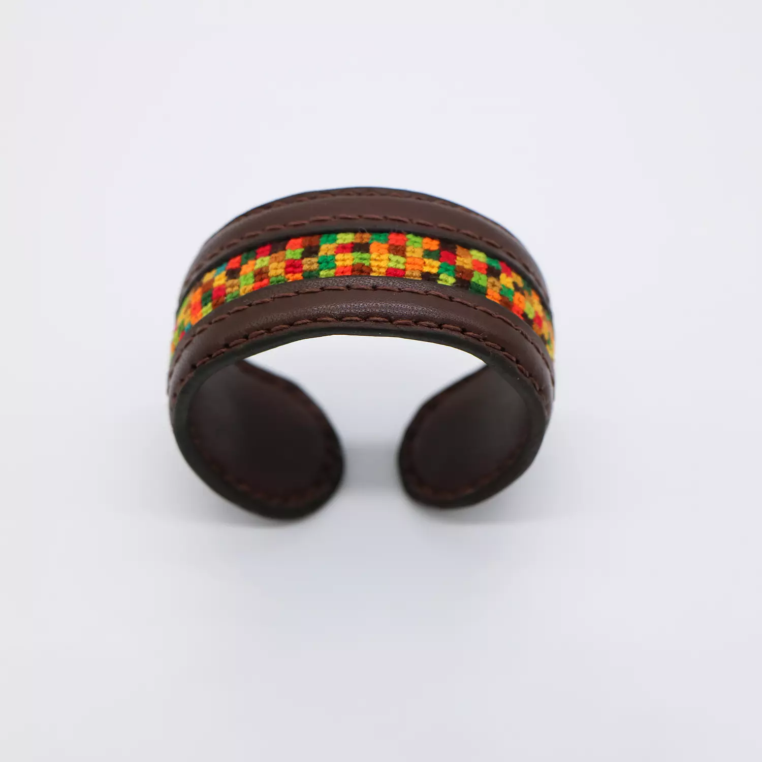 Dark brown genuine leather cuff with colorful Cross-stitching. hover image