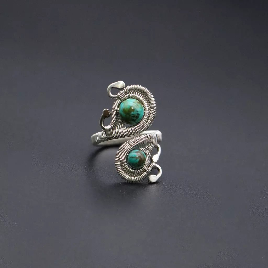 Silver ring with turquoise gemstones.