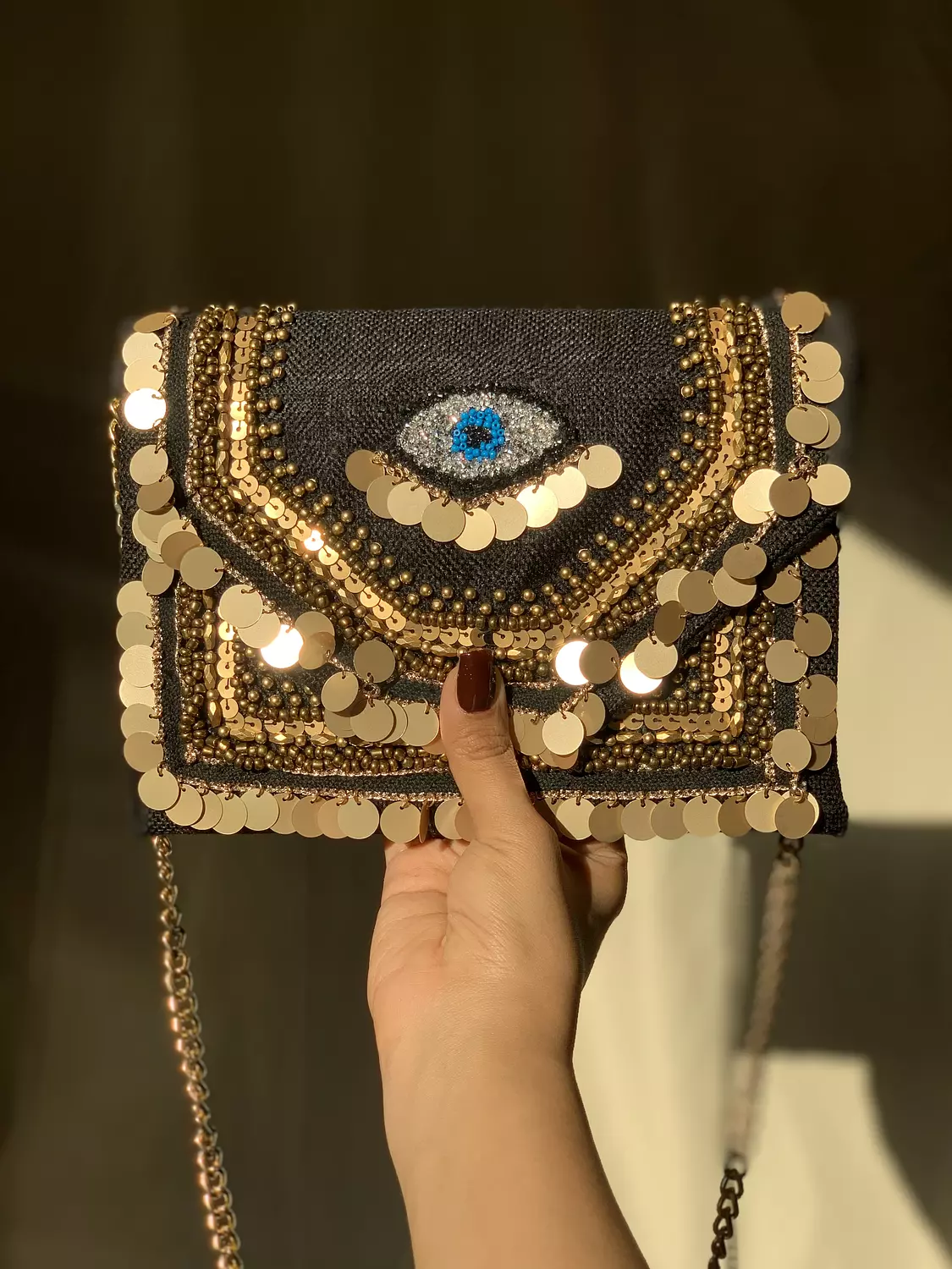 Black clutch with blue eyes hover image