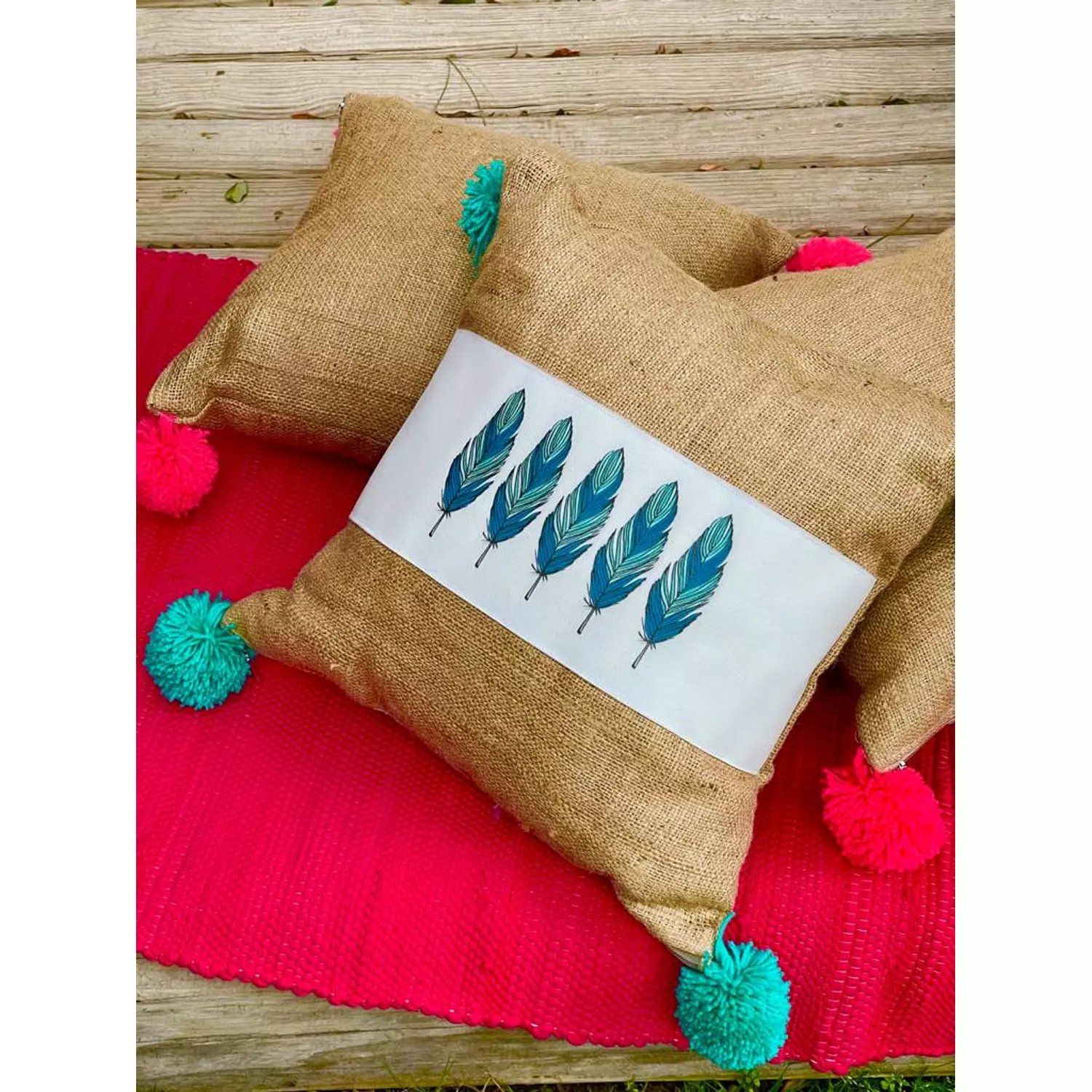 The Burlap Feather Cushion Turquoise Pompoms 1