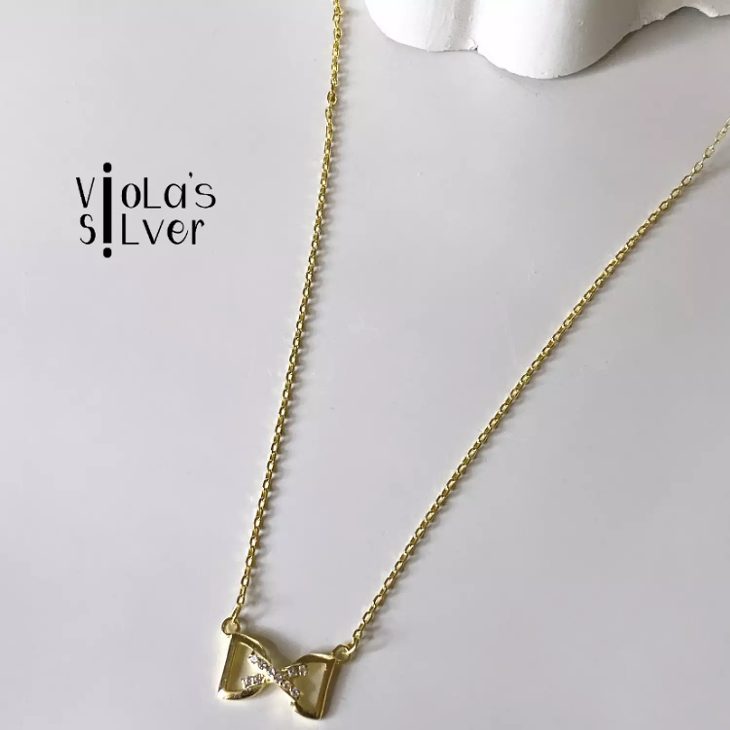 Golden ribbon necklace hover image