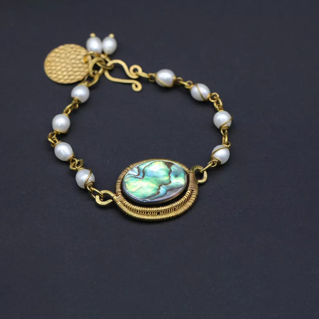 Brass bracelet with abalone shell and pearls.