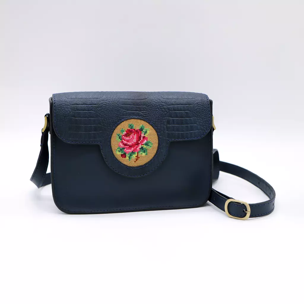 Genuine leather bag with floral design.